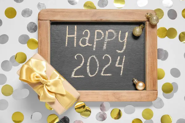 Blackboard Text Happy 2024 Gift Box Balls Confetti White Background — Stock Photo, Image