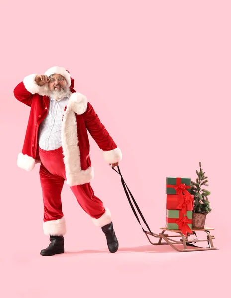 Santa Claus Pulling Sleigh Christmas Gifts Pink Background — Stock Photo, Image