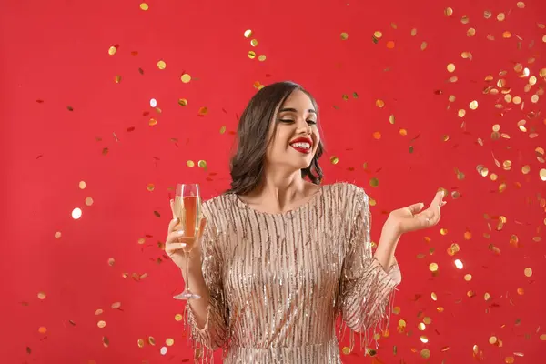 Young Woman Glass Champagne Falling Confetti Red Background New Year — Stock Photo, Image