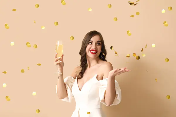 Young Woman Glass Champagne Falling Confetti Beige Background New Year — Stock Photo, Image