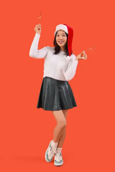 Young Beautiful Asian Woman Santa Hat Sparklers Red Background — Stock Photo, Image