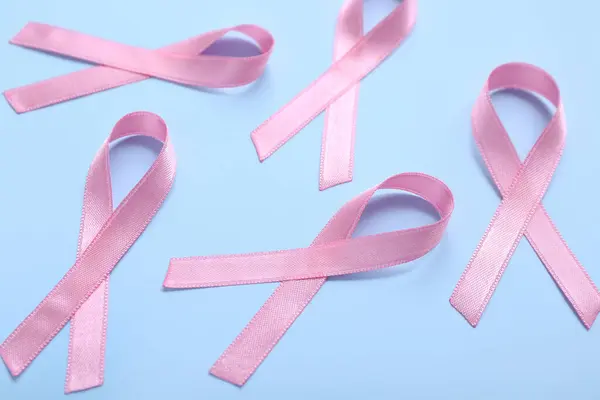 Pink ribbons on blue background. Breast cancer awareness concept