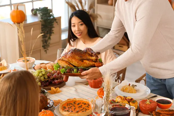 Young Man Bringing Tasty Turkey Dining Table His Friends Home — Stock Photo, Image