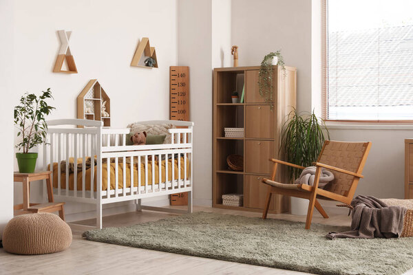 Interior of children's bedroom with crib, shelves and toys