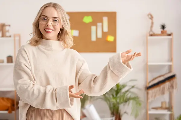 Female interior designer showing something in office