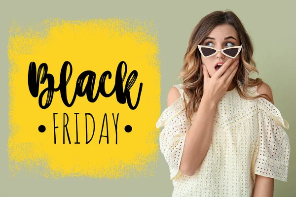 Surprised young woman and text BLACK FRIDAY on green background