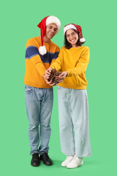 Happy Young Couple Santa Hats Forest Bumps Green Background — Stock Photo, Image