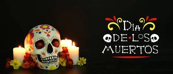 stock image Greeting banner for Mexico's Day of the Dead (El Dia de Muertos) with painted human skull, candles and flowers