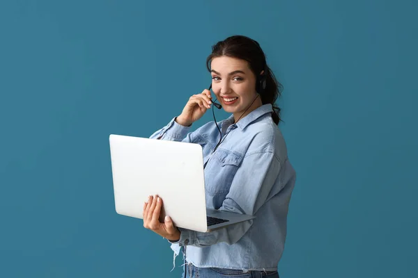 Female technical support agent with laptop on blue background