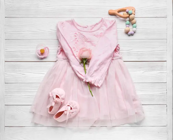 Komposition Mit Stilvollem Babykleid Accessoires Und Rosenblume Auf Hellem Holzhintergrund — Stockfoto