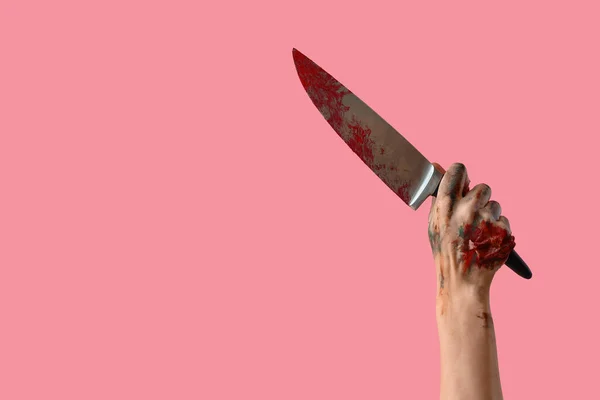 ピンクのバックグラウンドに血塗られたナイフでゾンビの手 ハロウィーンのお祝い — ストック写真