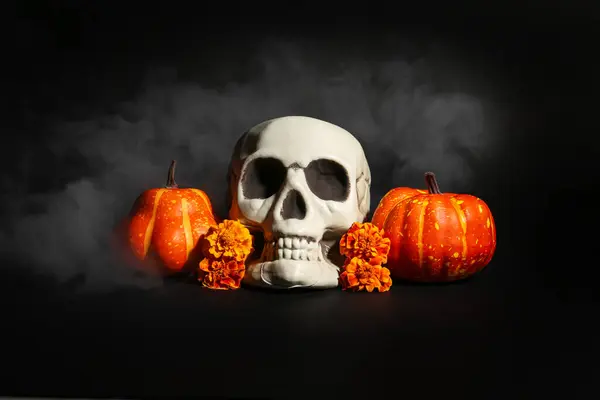 Halloween skull with pumpkins and marigold flowers on black background