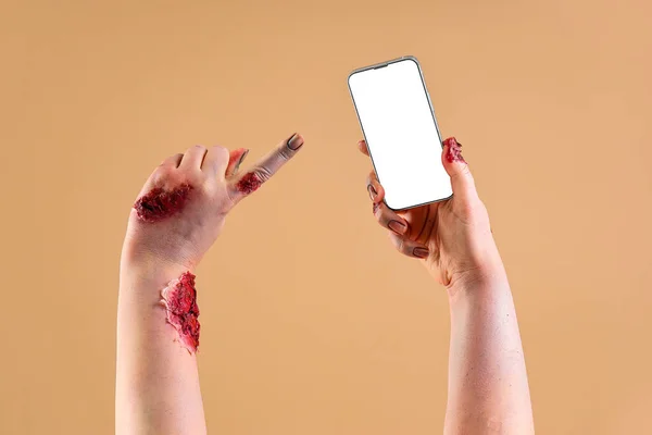 Зомби Руки Указывая Мобильный Телефон Пустым Экраном Бежевом Фоне Праздник — стоковое фото