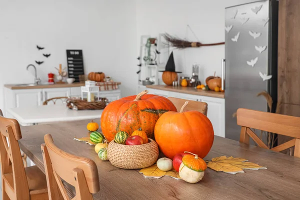 Halloween pumpkins on dining table in kitchen