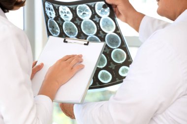 Doktorlar klinikteki röntgen taramasını inceliyor.