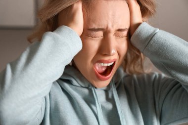 Evde panik atak geçiren genç bir kadın.