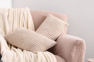 Yastıklı ve battaniyeli rahat koltuk, yakın çekim.