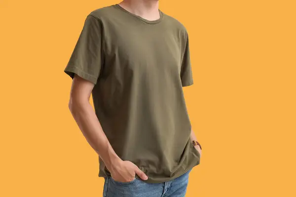 Man in stylish t-shirt on orange background