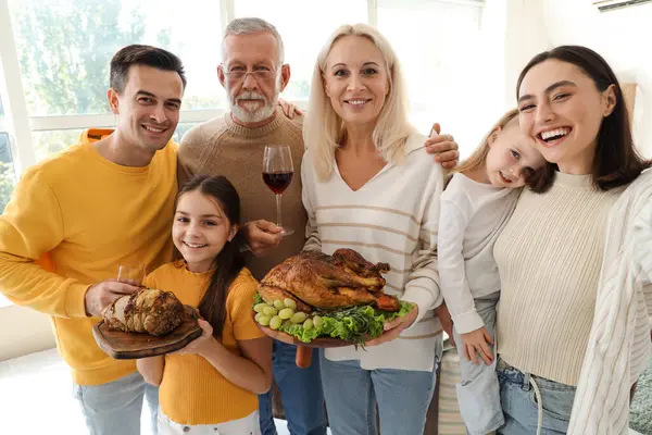 Happy family with tasty food at home on Thanksgiving Day