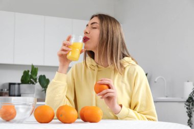 Bardak portakal suyu mutfak olan kadın