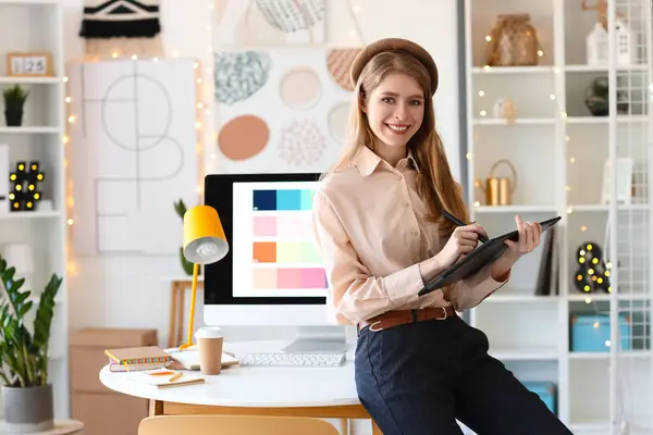 Female graphic designer with tablet working in office