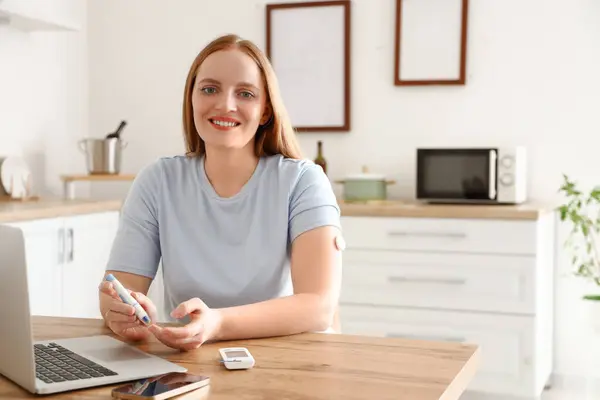 stock image Woman with diabetes measuring blood sugar level at home