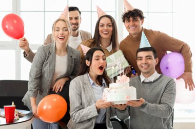 Group of business people with Birthday cake at party in office clipart