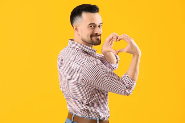 Handsome Man Making Heart His Hands Yellow Background — Stock Photo, Image