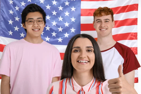 Young students of language school against USA flag, closeup