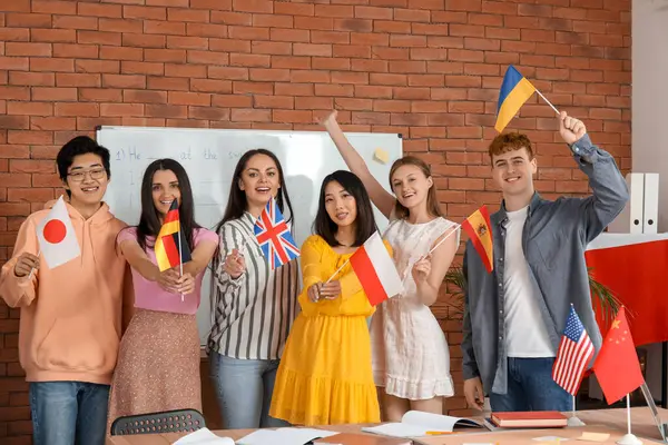 Young students with flags at language school