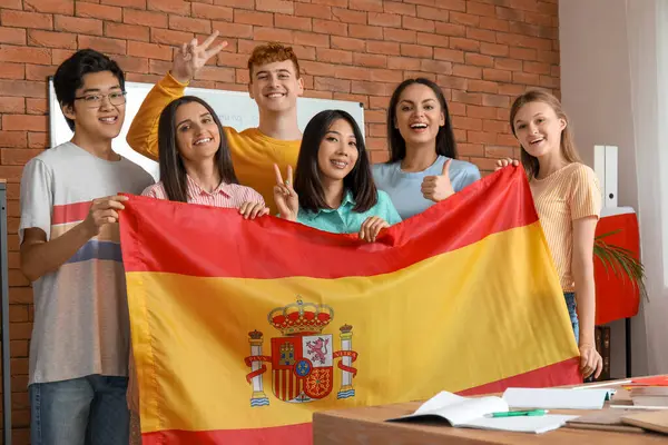 Young students with Spanish flag at language school