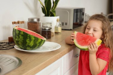 Mutfakta taze karpuz olan küçük bir kız.