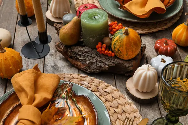 Autumn table serving with pumpkins on grey wooden table