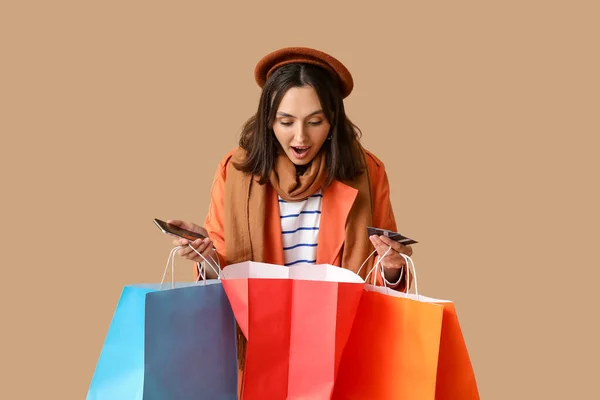 Young Woman Shopping Bags Credit Cards Mobile Phone Brown Background — Stock Photo, Image