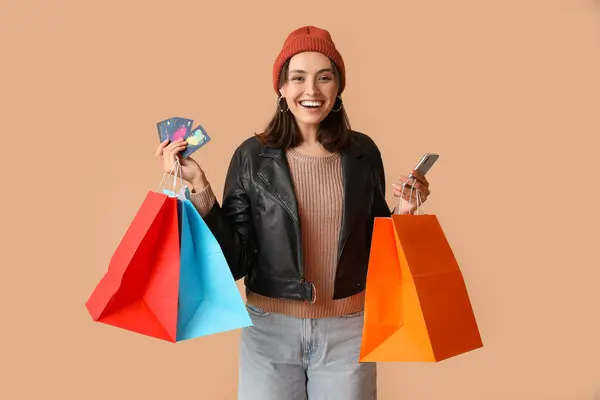 Young Woman Shopping Bags Credit Cards Mobile Phone Brown Background — Stock Photo, Image