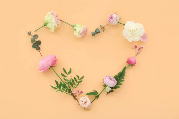 Heart made from flowers on beige background. National Sweetest Day