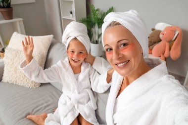 Küçük kız ve büyükannesi göz altı bantlı, yakın plan.