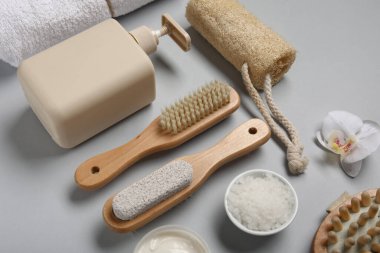 Gri arka planda farklı banyo malzemeleri ve kozmetik ürünleri içeren kompozisyon, yakın plan