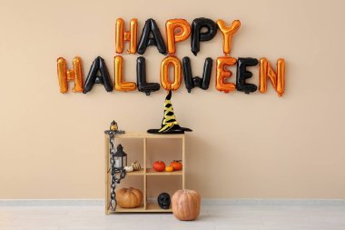 Rafa kaldırma ünitesi ve mesaj Salondaki bej duvarda asılı balonlardan yapılmış Mutlu Cadılar Bayramı