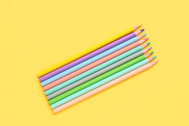 Sarı arkaplanda renk kalemleri kümesi