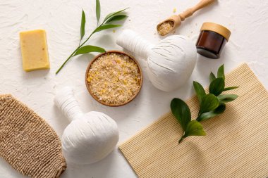 Kaplıca aksesuarları ve hafif arka planda bitki dalları ile kompozisyon