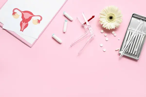 Gynecological speculum, pills, pap smear test tools, drawing of female uterus and menstrual tampons on pink background