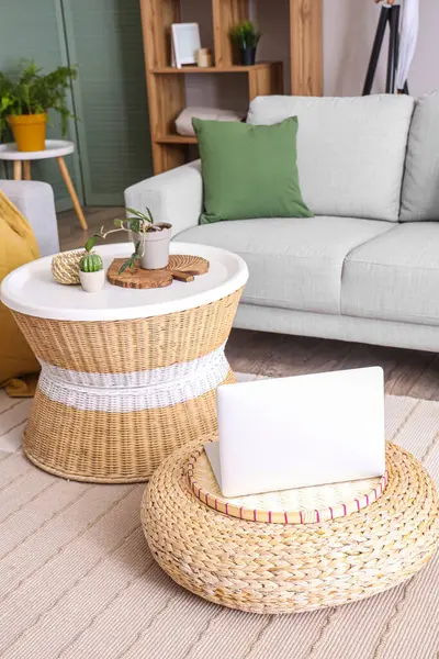 Wicker table with different home decor in stylish living room