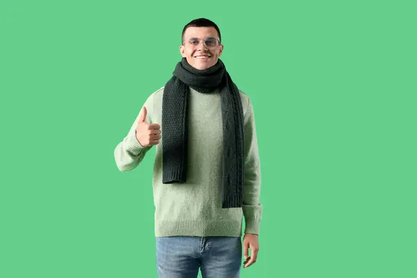 Young Man Winter Clothes Showing Thumb Green Background — Stock Photo, Image
