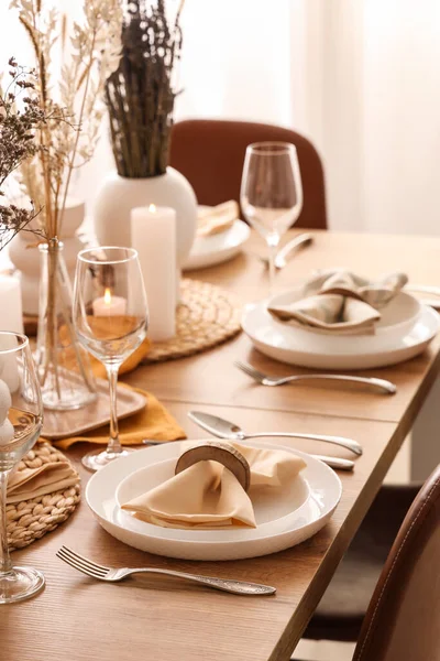 Elegant table setting with folded napkins, cutlery and plates