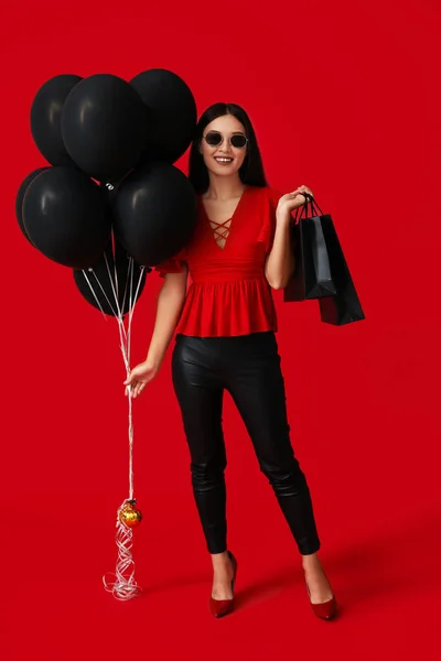 Beautiful Young Asian Woman Shopping Bags Balloons Red Background Black — Stock Photo, Image