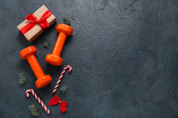 stock image Composition with dumbbells, Christmas decorations and gift on dark background