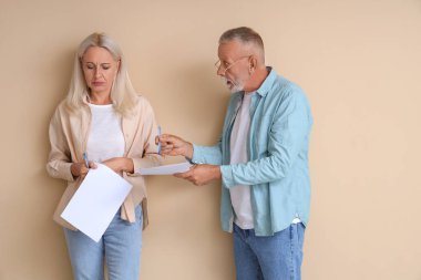 Bej arkaplanda boşanma kararı olan olgun bir çift.