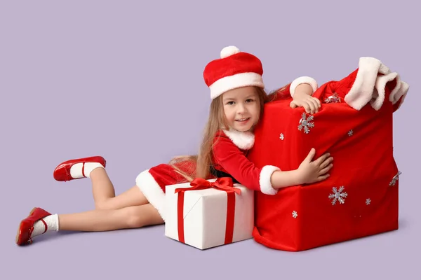 Cute Little Girl Santa Claus Costume Bag Gifts Lilac Background Royalty Free Stock Photos