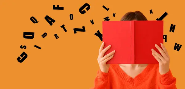 Woman with red book and many English letters on orange background
